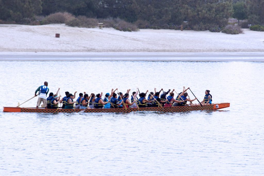 Paddle a long boat.