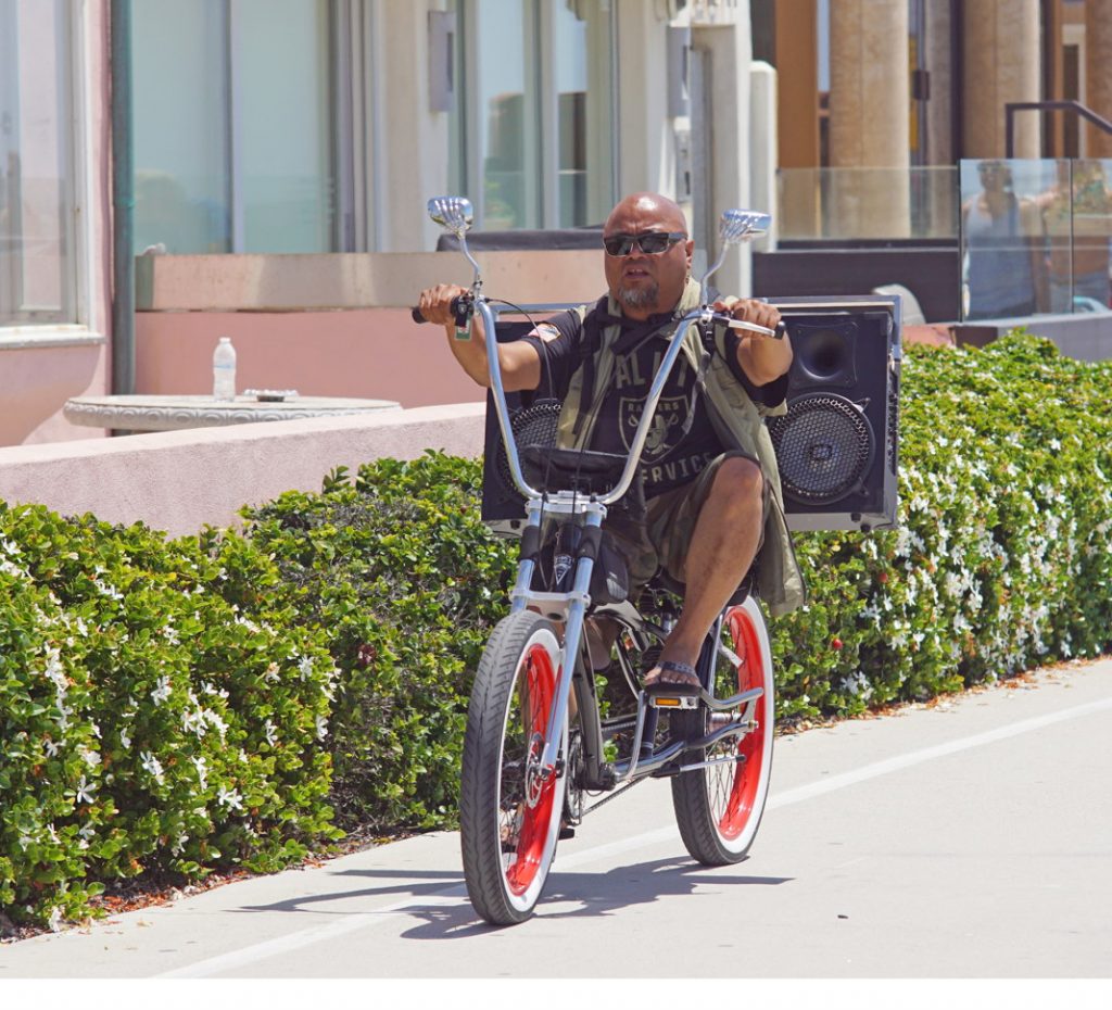 Ride a bike with a really big ghetto-blaster.