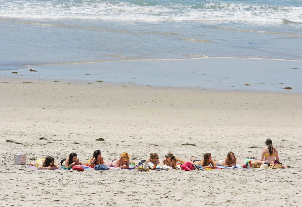 Work on your tan with your friends in a line.