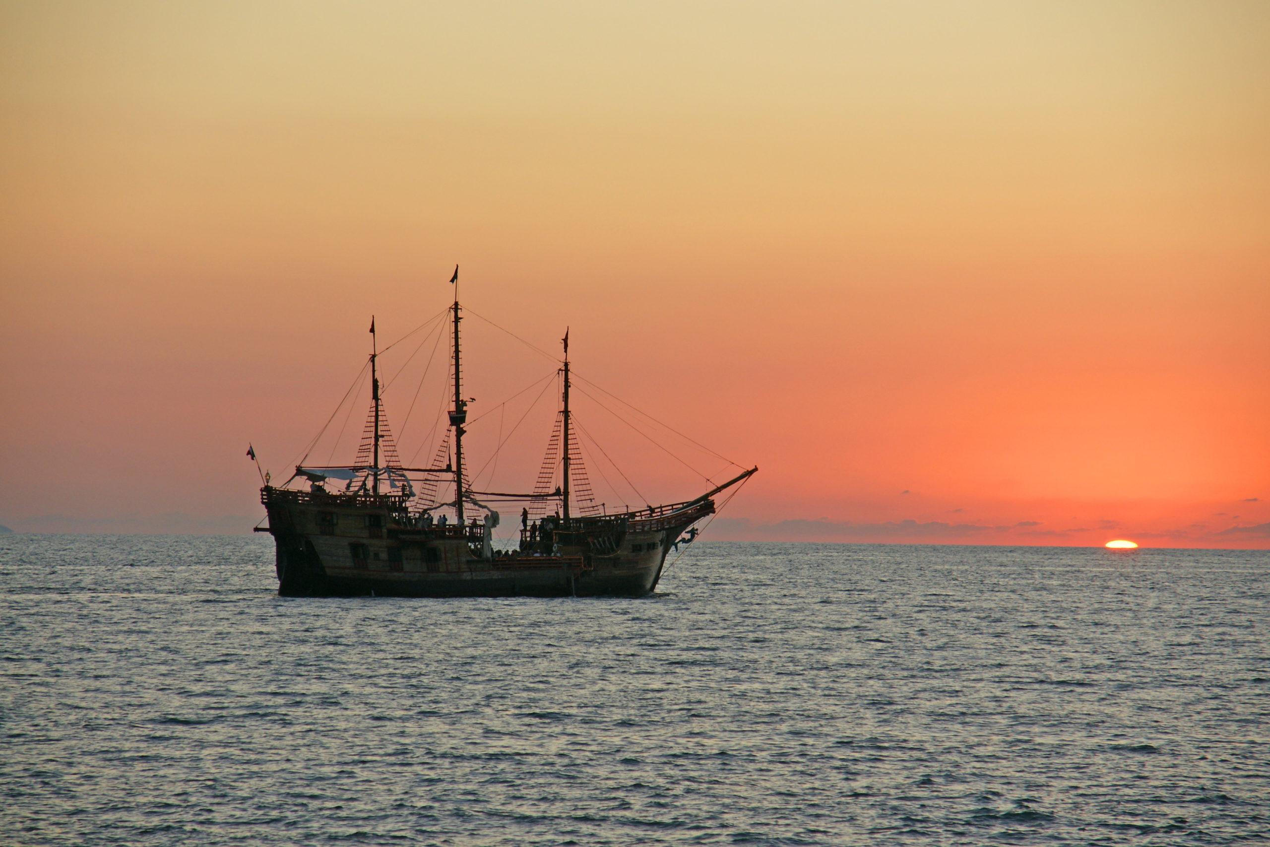 A pirate crew enjoys the sunset.