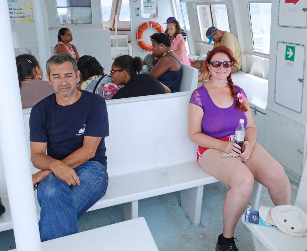 Happily riding with bored passengers on the ferry.