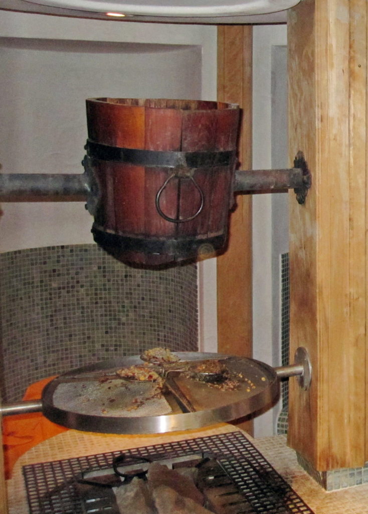 Traditional sauna, making steam with cold water poured on hot rocks.