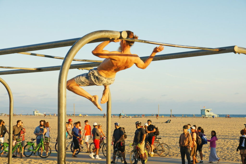 Swinging from bar to bar on the Monkey Bars.