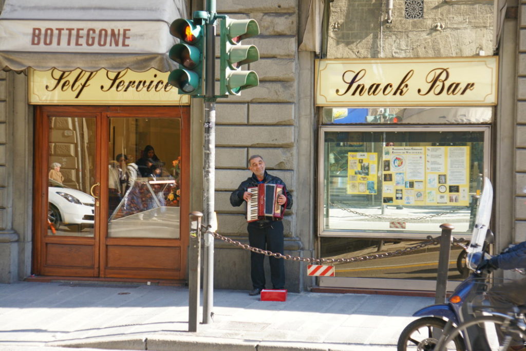 Playing the accordion by the snack bar.