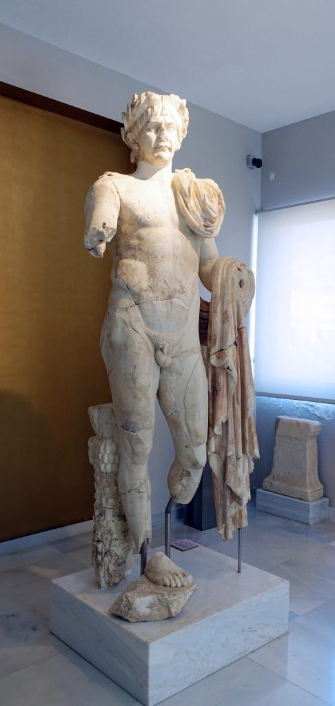 A colossal portrait statue of the emperor Trajan greets visitors.