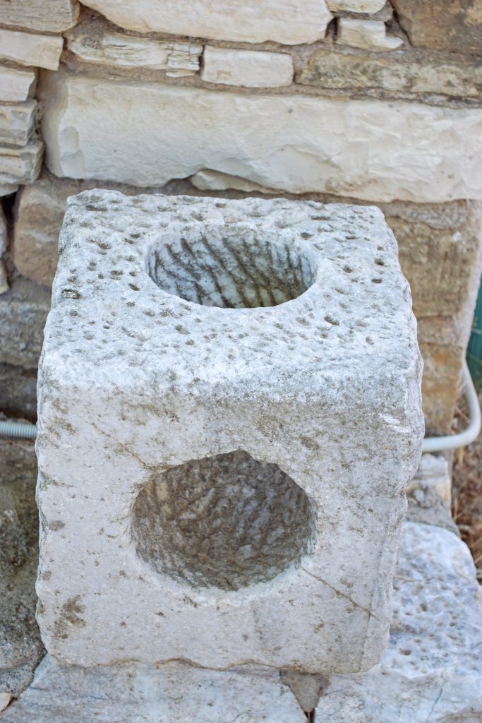 This cubic stone has a curved tunnel carved through it.