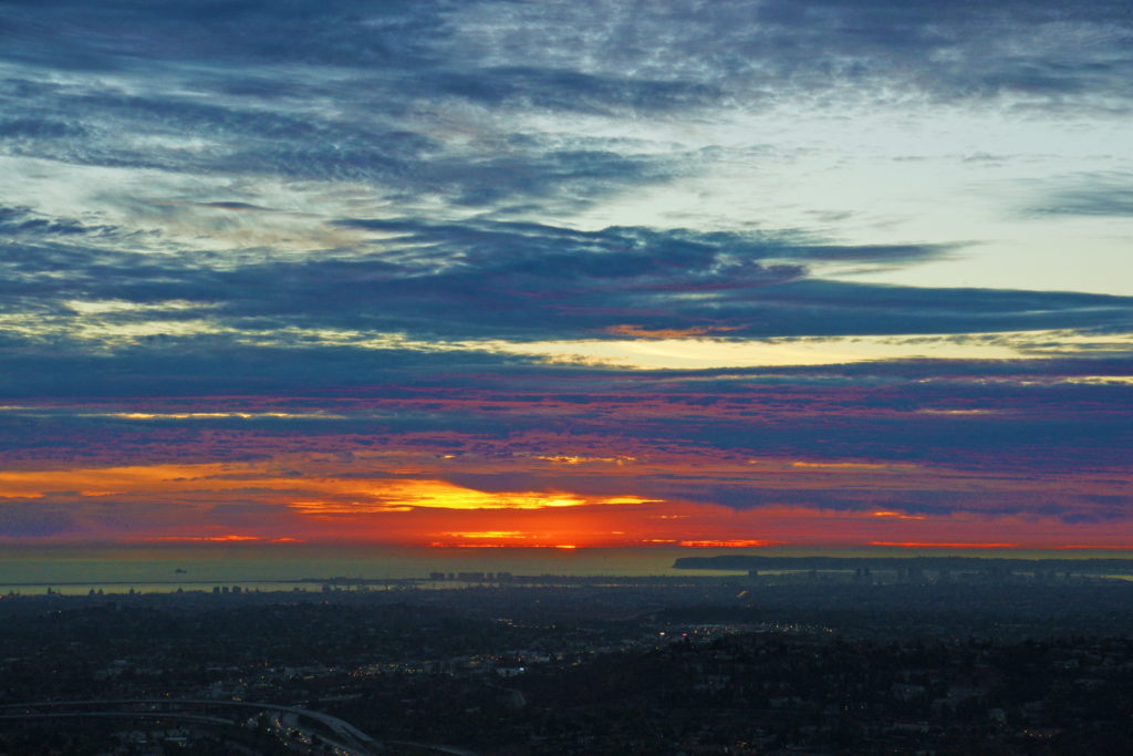 The sun colors the sky all shades of red and yellow.