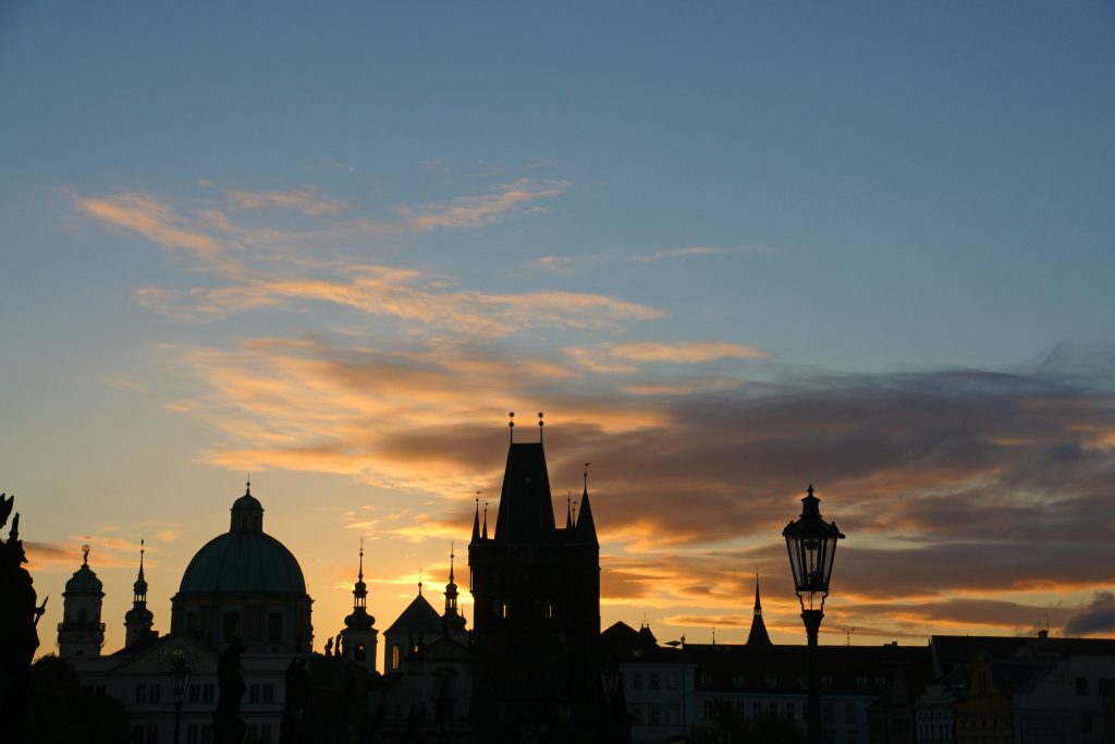 The sun rises over the Old Town Bridge tower.