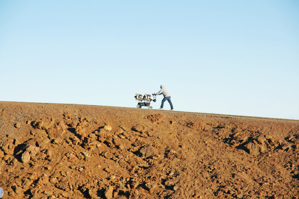 A man pushing a stroller on Haleakalā.