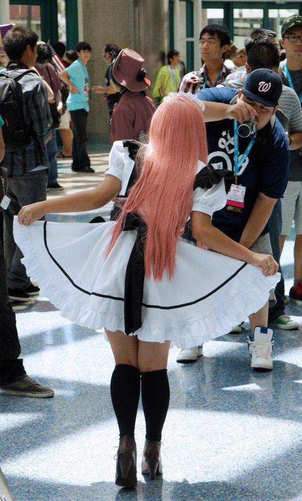 An anime creature shows off her pretty white skirt.