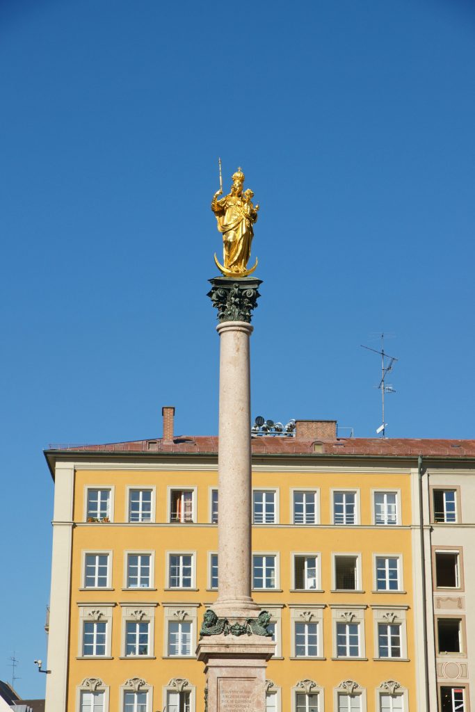 The Marian column is crowned by a gilt bronze statue of Christian's God's mom.