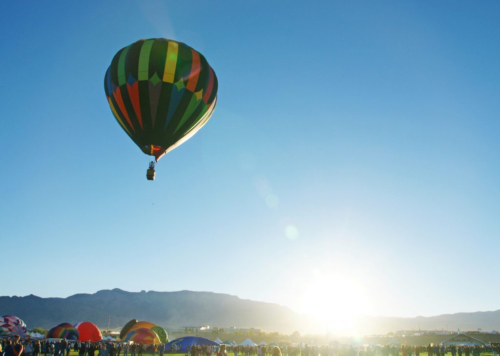 A lone balloon ascends.