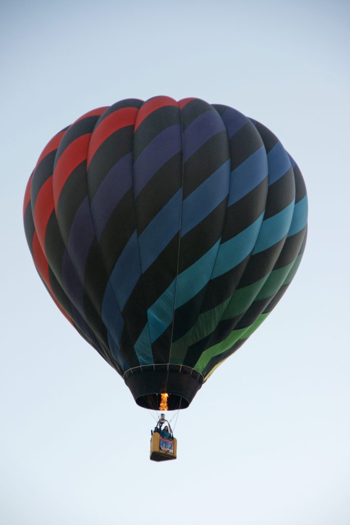 A girl in a tiny basket rises aloft.