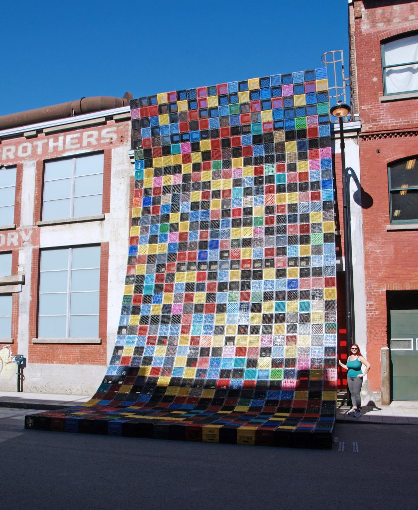 A Canadian quilt shades a building.