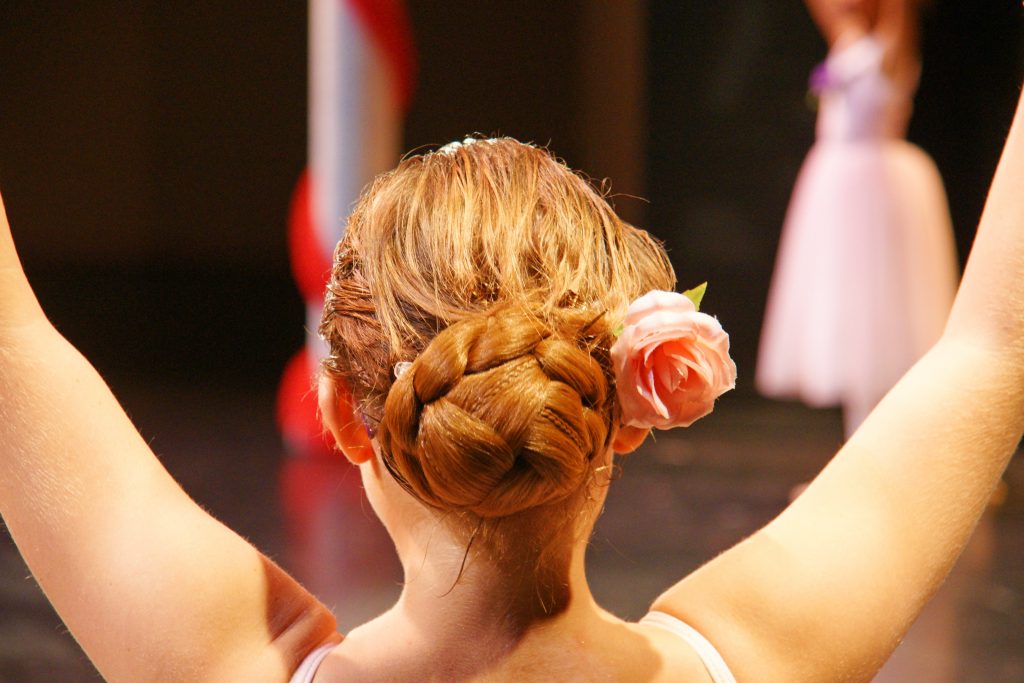 An ersatz bunhead prepares to enter from the wings.