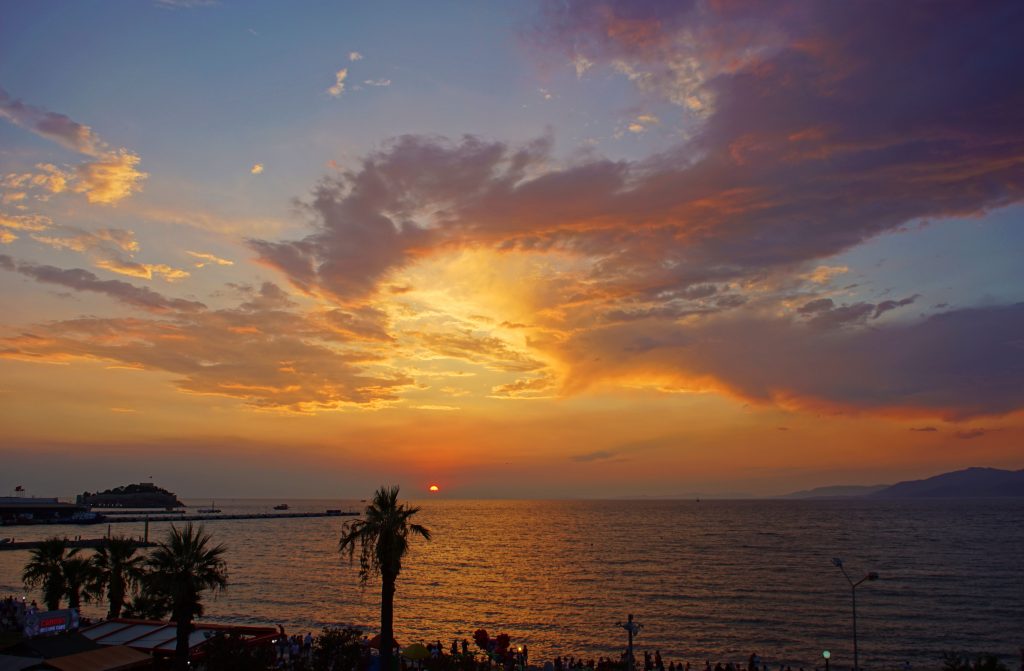 The sky turns other-worldly-orange-and-yellow as the sun disappears over the horizon.