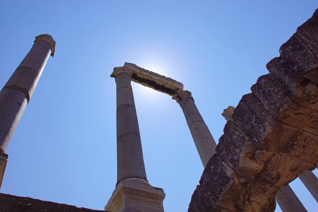 Mighy Helios, eclipsed by a marble ruin.