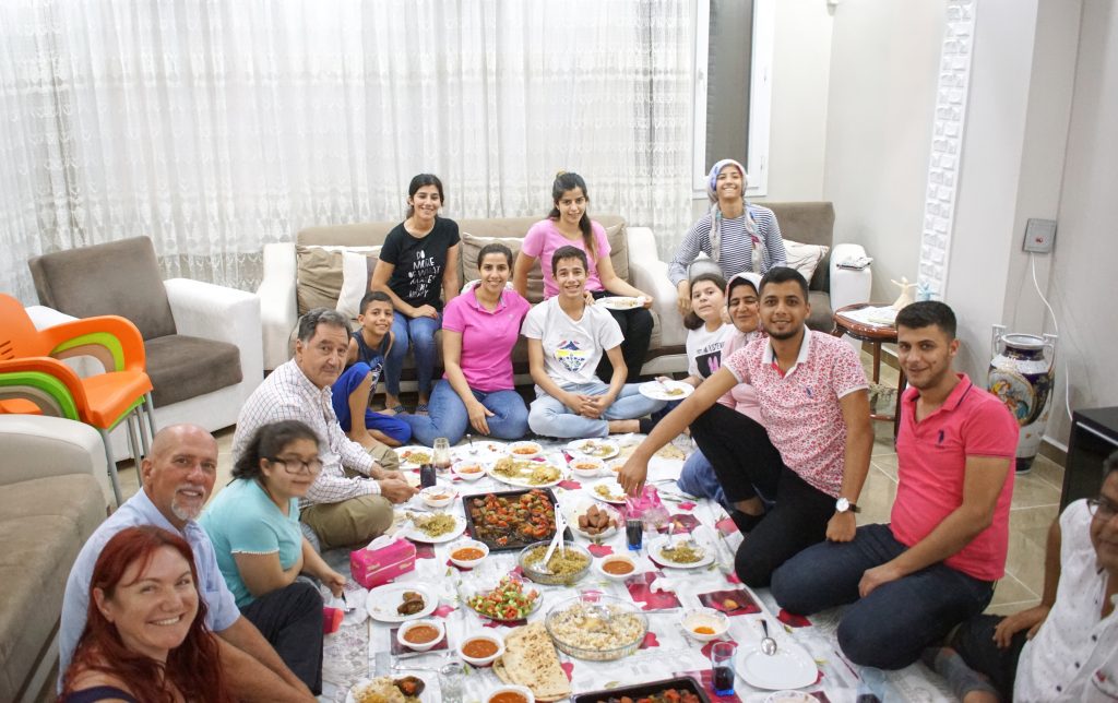 Part of the dinner party, enjoying dinner.