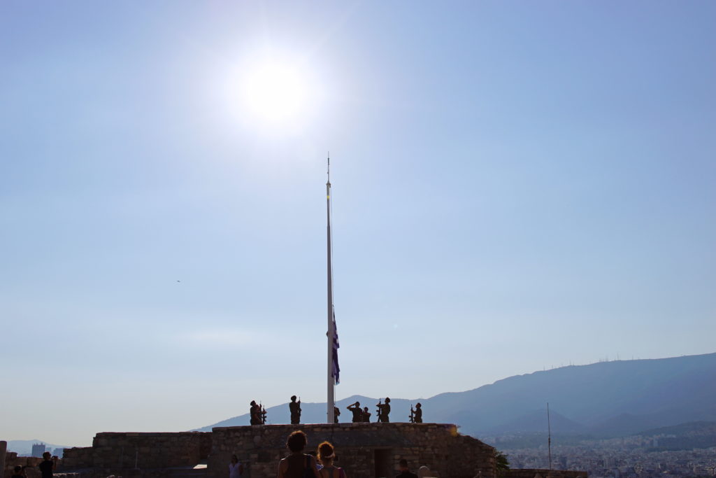 Ever so slowly, the flag ascends the pole.