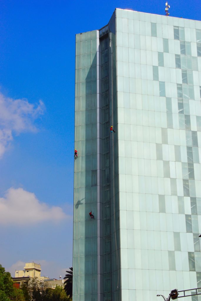 Spiderman, Spiderman, washes the windows as fast as he can.