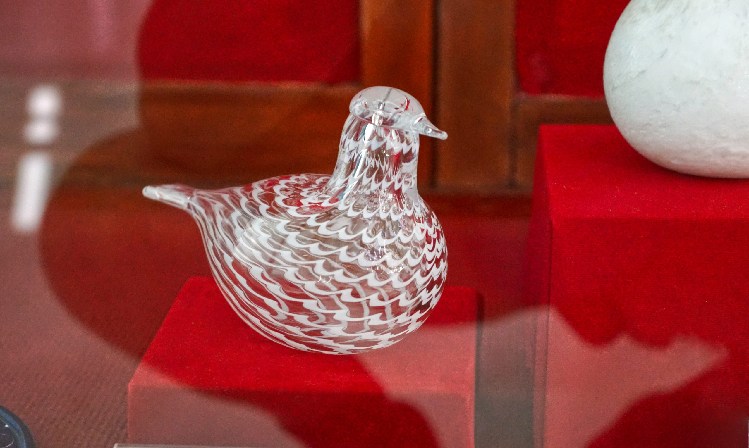 Glass bird behind glass.