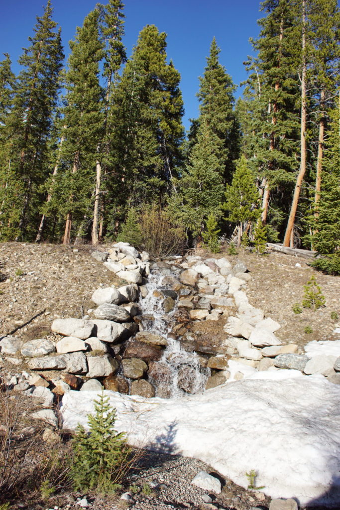 A mighty waterfall carves a mountain valley.