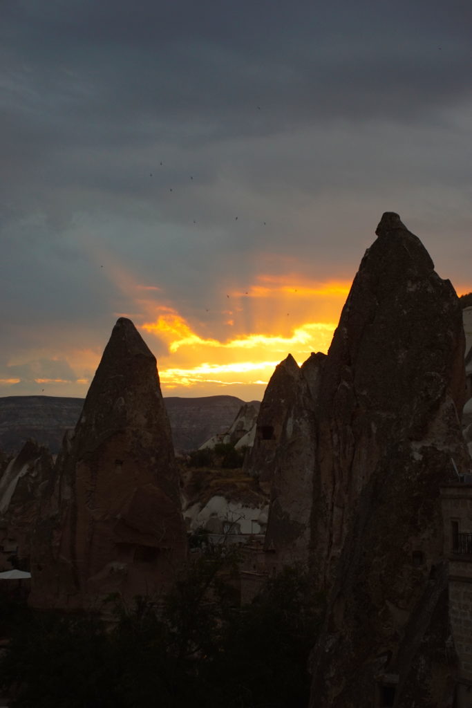 The setting sun ignites the Cappadocian skies.