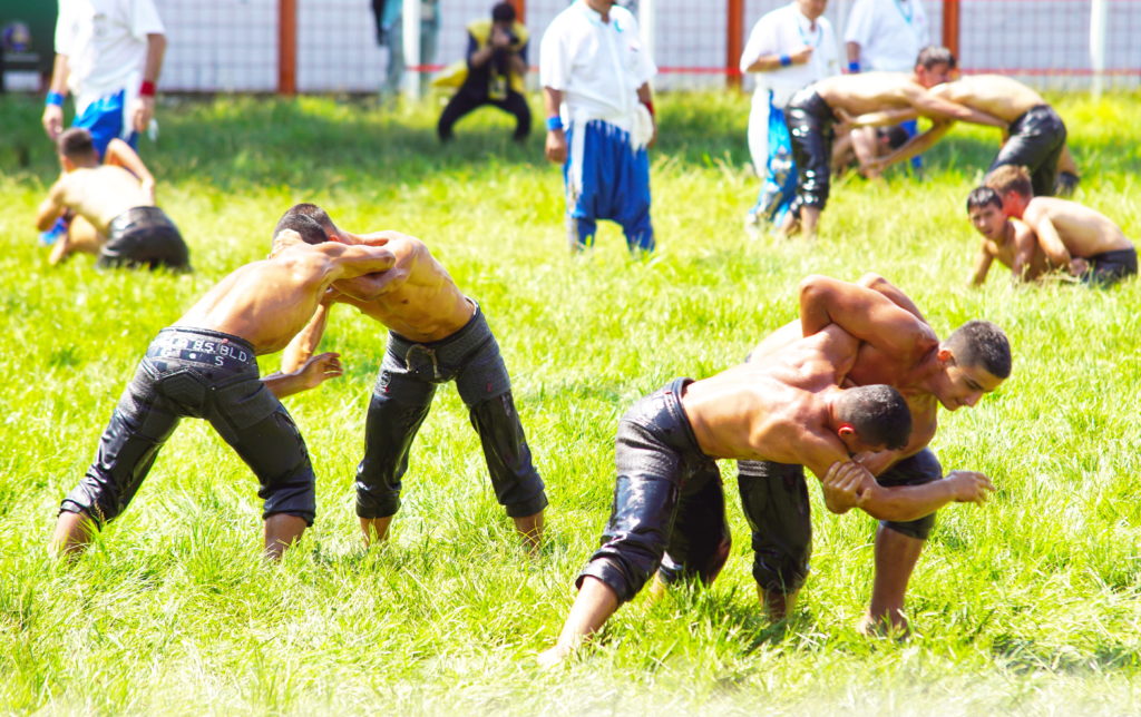 Oily, muscled bodies view for victory.